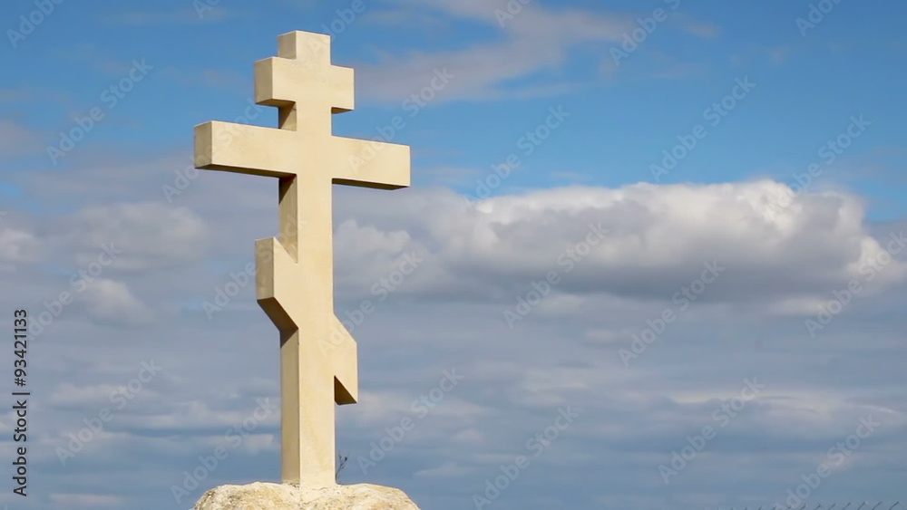 Orthodox stone cross against blue sky background, belief in God, religion Orthodox stone cross against blue sky background, belief in God, religion