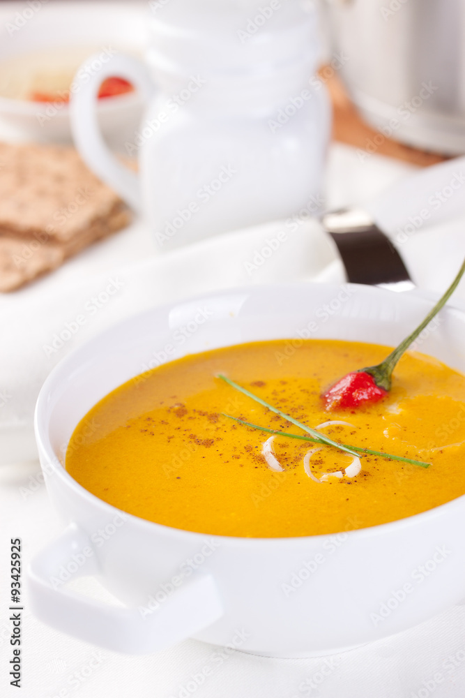 Vegetable soup with pumpkin, carrot, red pepper and cream in white bowl on white background. Vegetable soup with pumpkin, carrot, red pepper and cream in white bowl on white background.