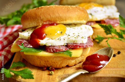 Burger with cheese salami and fried egg.