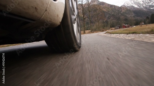 Car wheel on mountain road photo