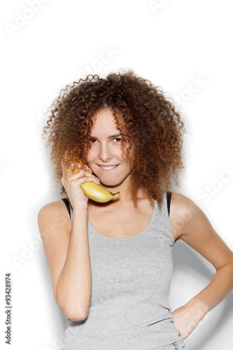  Young pretty woman making fun with banana