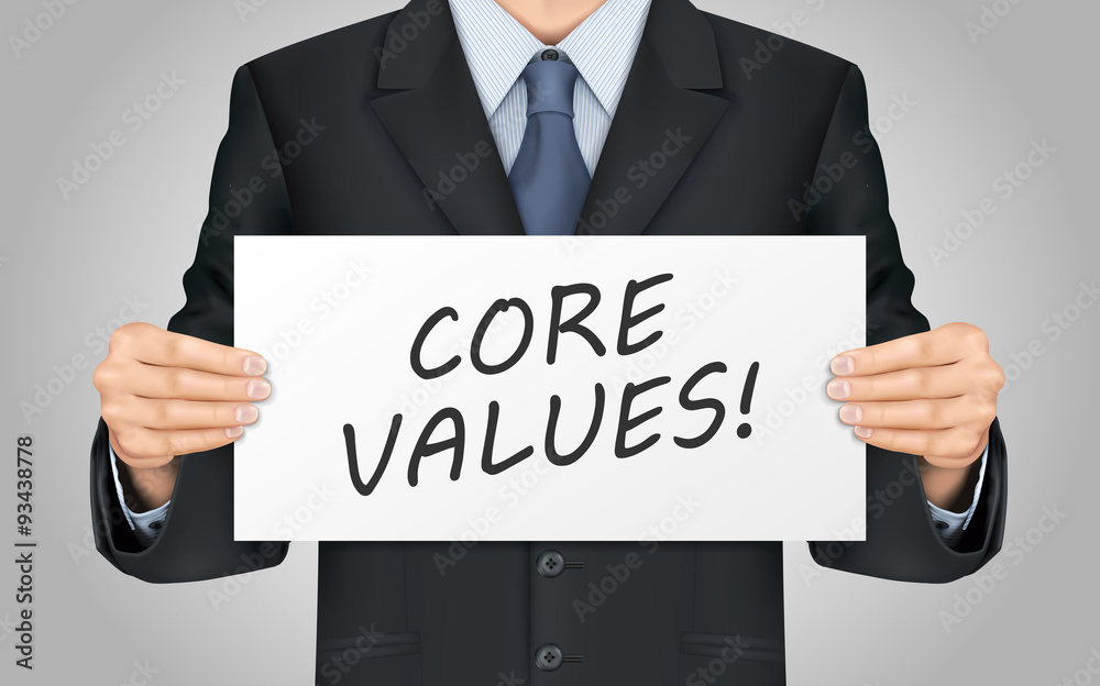 businessman holding core values poster businessman holding core values poster