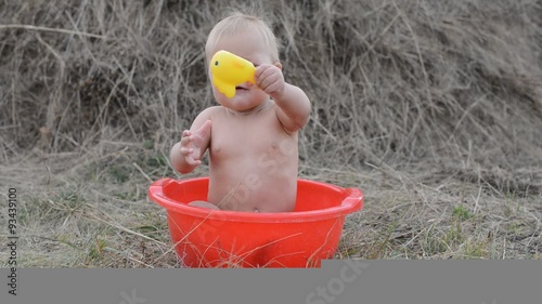 a small child plays with toys in the park on the grass