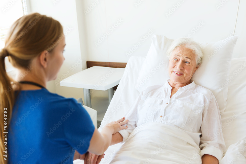 Fototapeta premium doctor or nurse visiting senior woman at hospital