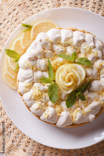 lemon meringue pie close-up on a plate. vertical top view