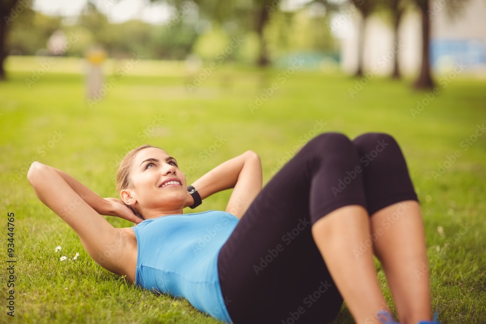 Woman doing stretching exercise with hands behind head Woman doing stretching exercise with hands behind head