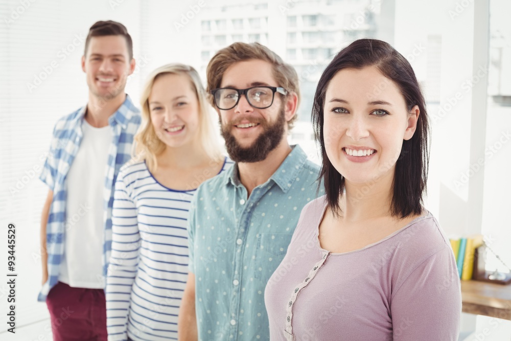Fototapeta premium Portrait of smiling business people standing in row 