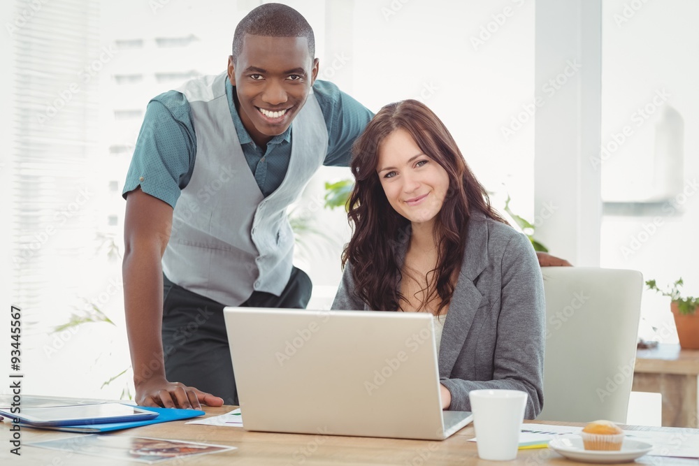 Portrait of smiling business couple working on laptop Portrait of smiling business couple working on laptop