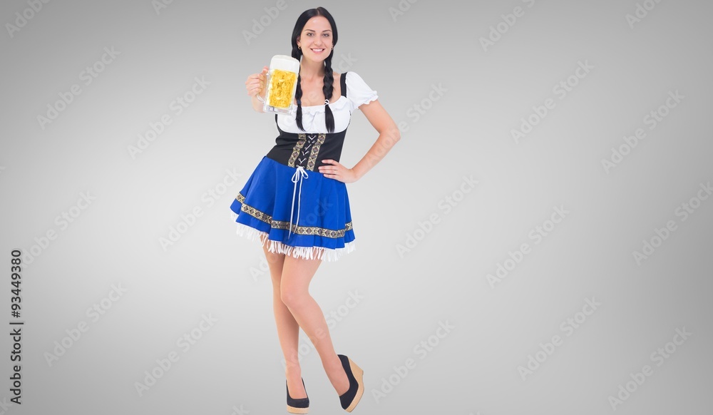 Composite image of pretty oktoberfest girl holding beer tankard Composite image of pretty oktoberfest girl holding beer tankard