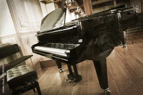 Grand-piano with a chair in the hall photo