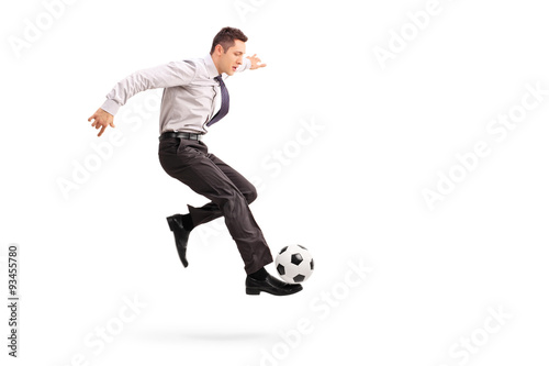 Young businessman kicking a football © Ljupco Smokovski