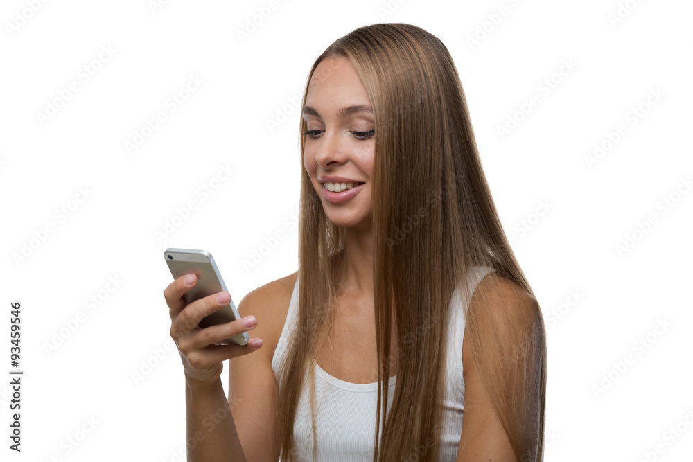 Woman looks at the smartphone screen and smiles Woman looks at the smartphone screen and smiles