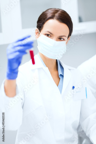 close up of scientist holding test tube in lab