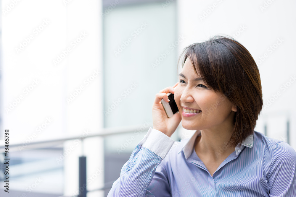 Asian businesswoman using mobile phone at office Asian businesswoman using mobile phone at office