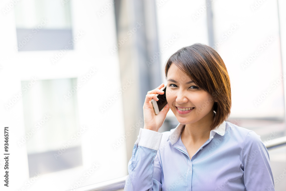 Asian businesswoman using mobile phone at office Asian businesswoman using mobile phone at office
