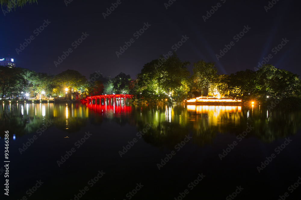 The Huc bridge across Hoan Kiem lake at night in Hanoi, Vietnam