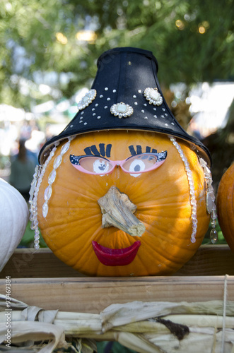 decorated pumpkin as an old lady with hat and makeup.  good for seasonal