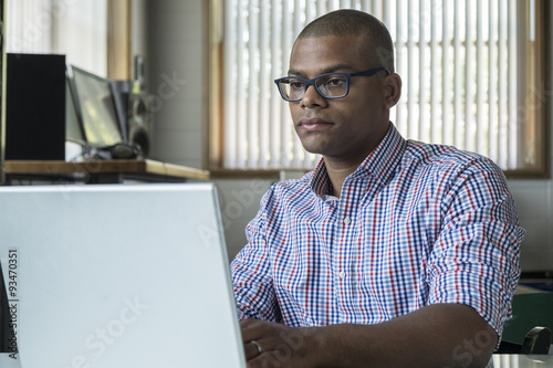 Young professional working on a computer in an office