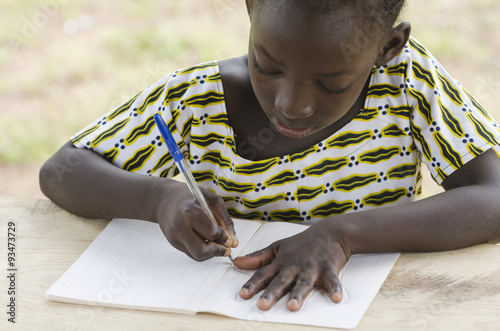 Black African Girl drawing and writing in her workbook in an African school in Bamako, Mali. Educational symbol for Africa. photo