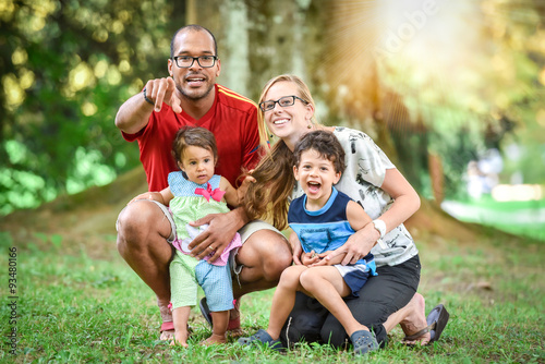 Happy interracial family is enjoying a day in the park © _jure