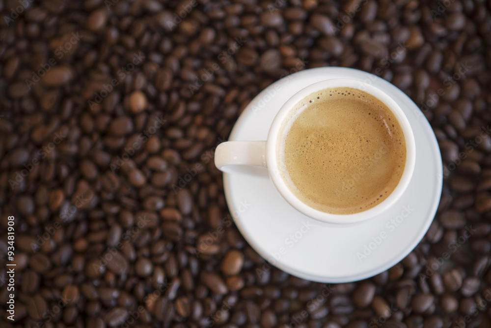 cup of coffee and beans on table cup of coffee and beans on table