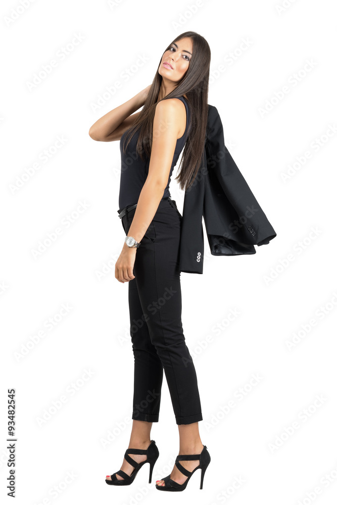 Young tanned attractive beauty in suit putting jacket over the shoulder isolated Young tanned attractive beauty in suit putting jacket over the shoulder isolated