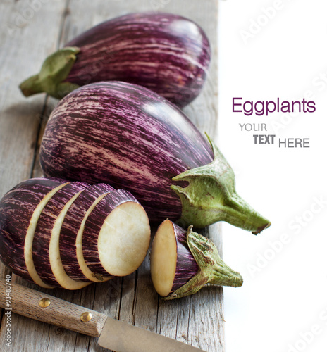 Fresh Raw striped eggplants and slices with knife