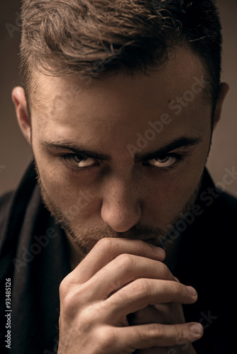 Shocked young man on dark background