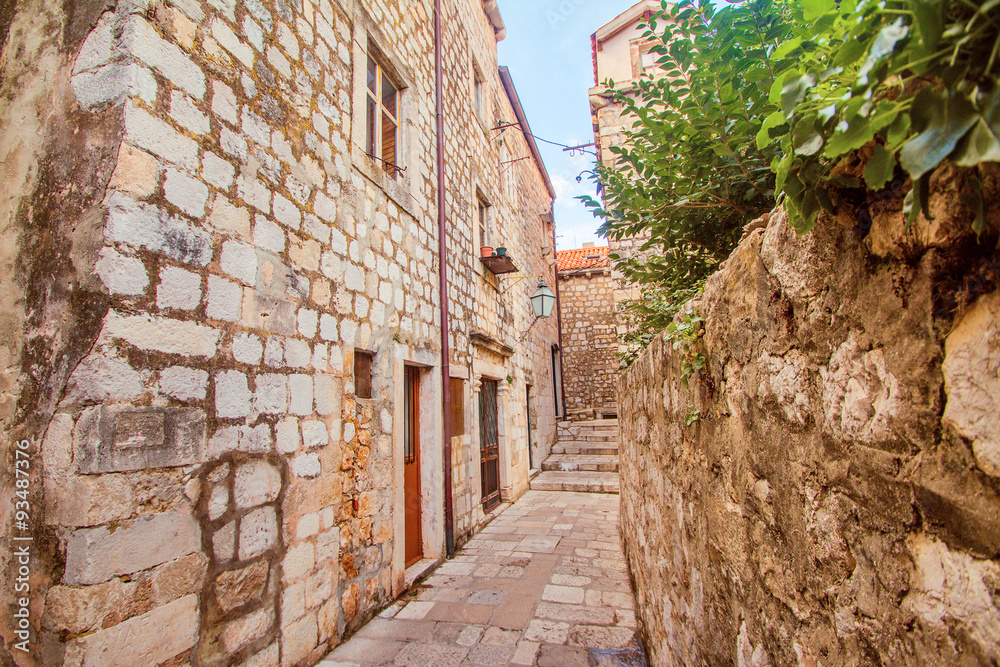 Narrow street and houses walls in the Old Town in Dubrovnik, Croatia 