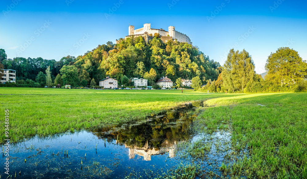 Idyllic summer fields and lakes with Fortress Hohensalzburg at sunset, Salzburger, Austria