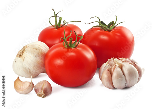 Fresh ripe tomatoes and garlic on white
