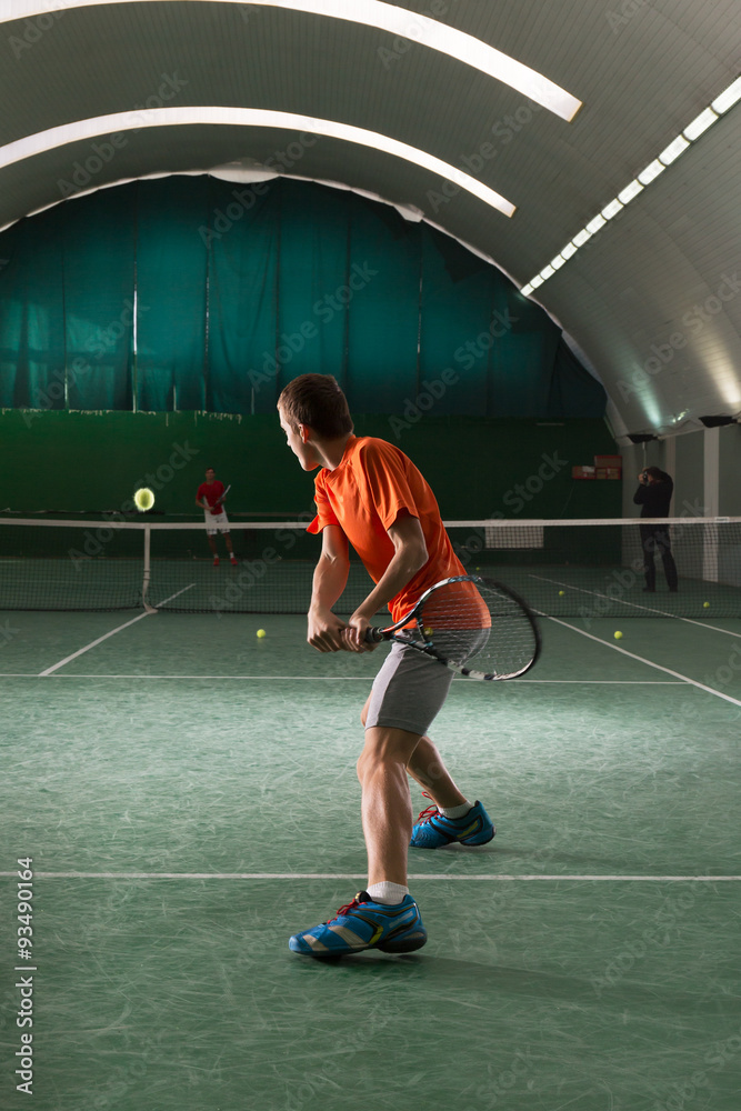 Young tennis player kicking the bal Young tennis player kicking the bal