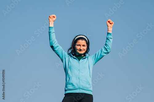 Happy woman holding hands up