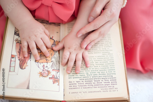 children's hands and picture book