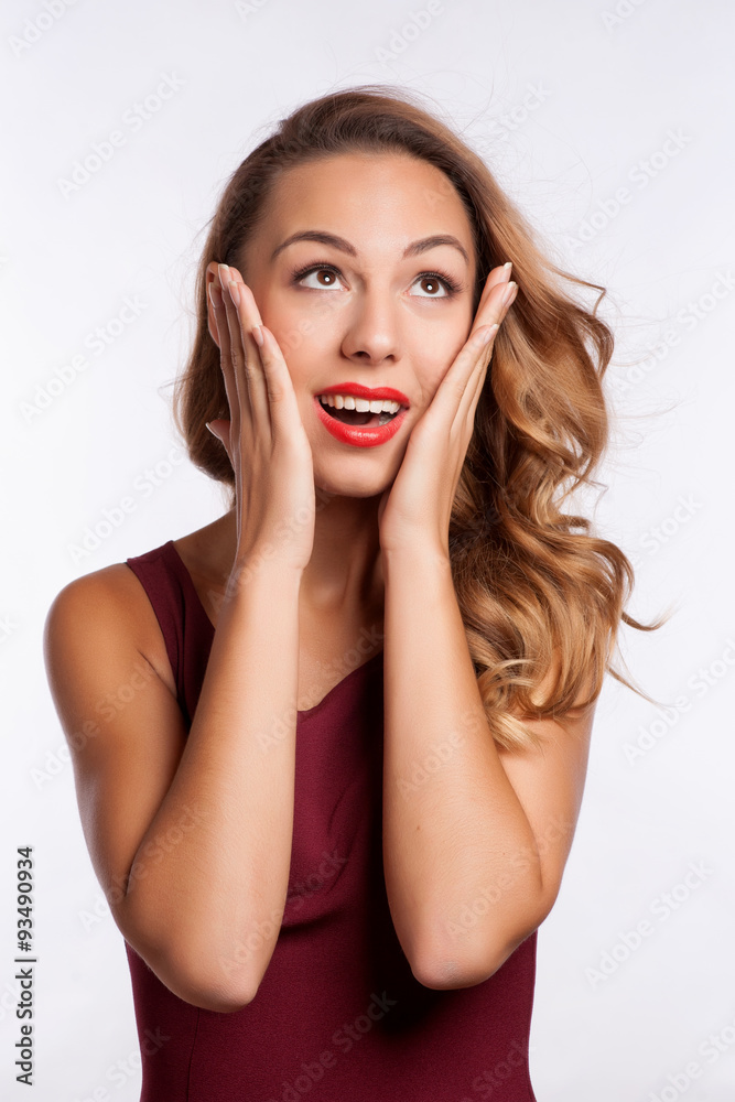 Close-up of a young woman looking surprised on white background - obrazy, fototapety, plakaty 