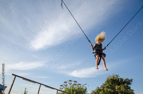 child jumping in bungee attraction