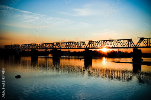 Fototapeta Naklejka Na Ścianę i Meble -  Bridge across the river at sunset