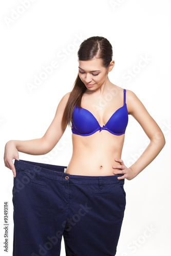 Woman in dieting concept with big pants Big pants weight loss woman