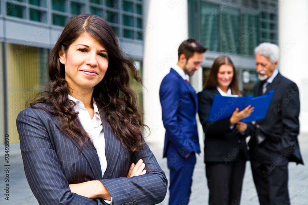 Beautiful woman on the background of business people Beautiful woman on the background of business people