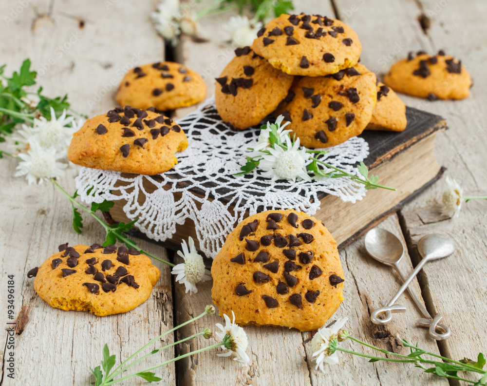 Cookies with chocolate on old books with fresh flowers.selective focus Cookies with chocolate on old books with fresh flowers.selective focus
