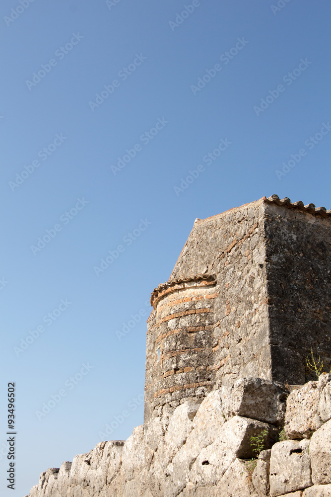 Stone byzantine building on blue sky with copy-space.