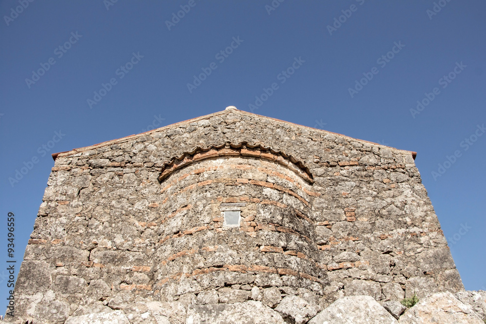Stone byzantine building on blue sky with copy-space.