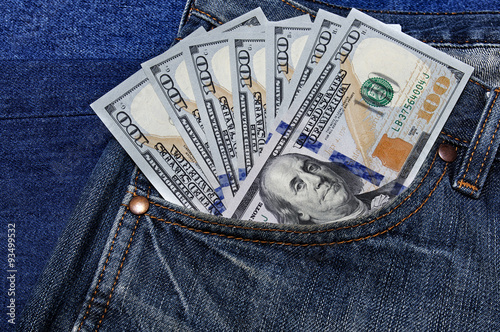 Several of banknotes hundred dollars of USA sticking out of his jeans pocket