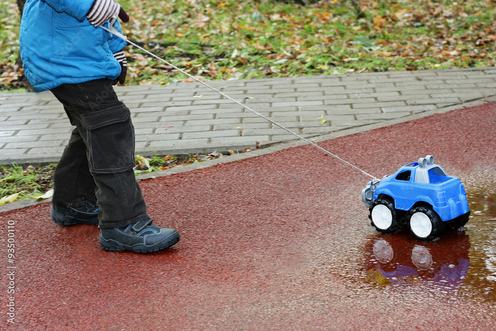 Child and toy car Child and toy car