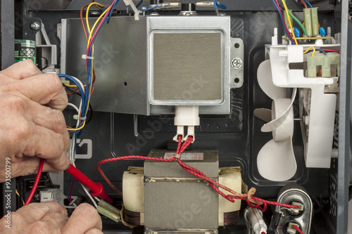 electrical engineer testing a microwave oven transformer