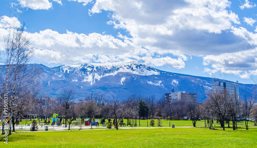 young bulgarians are walking through park in student city in sofia with vitosha mountain on background. photo