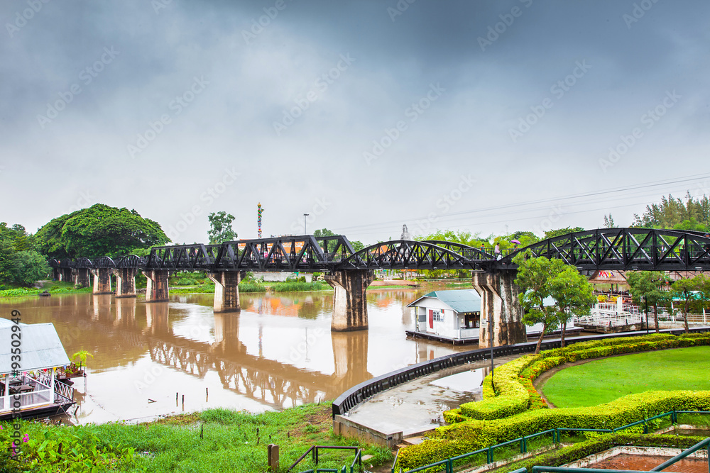 Fototapeta premium Railway Bridge in the rain cloud, River Kwai, Kanchanaburi, Thailand