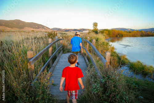 Boys walking over a foot bridge