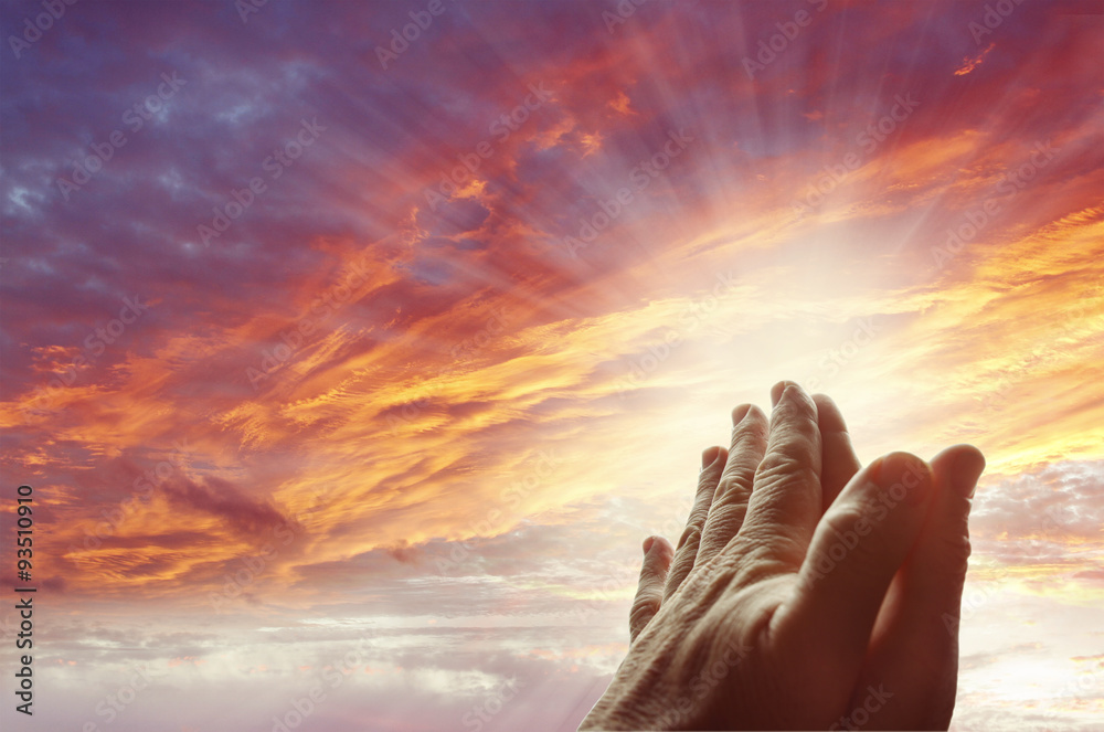 Hands together praying. Bright sky light. Prayer