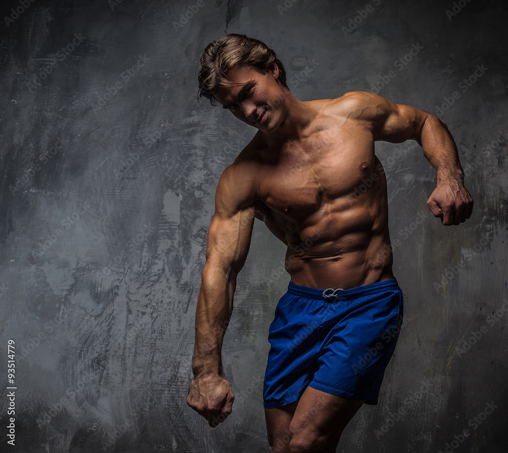 Fototapeta premium Strong muscular bodybuilder showing his body.